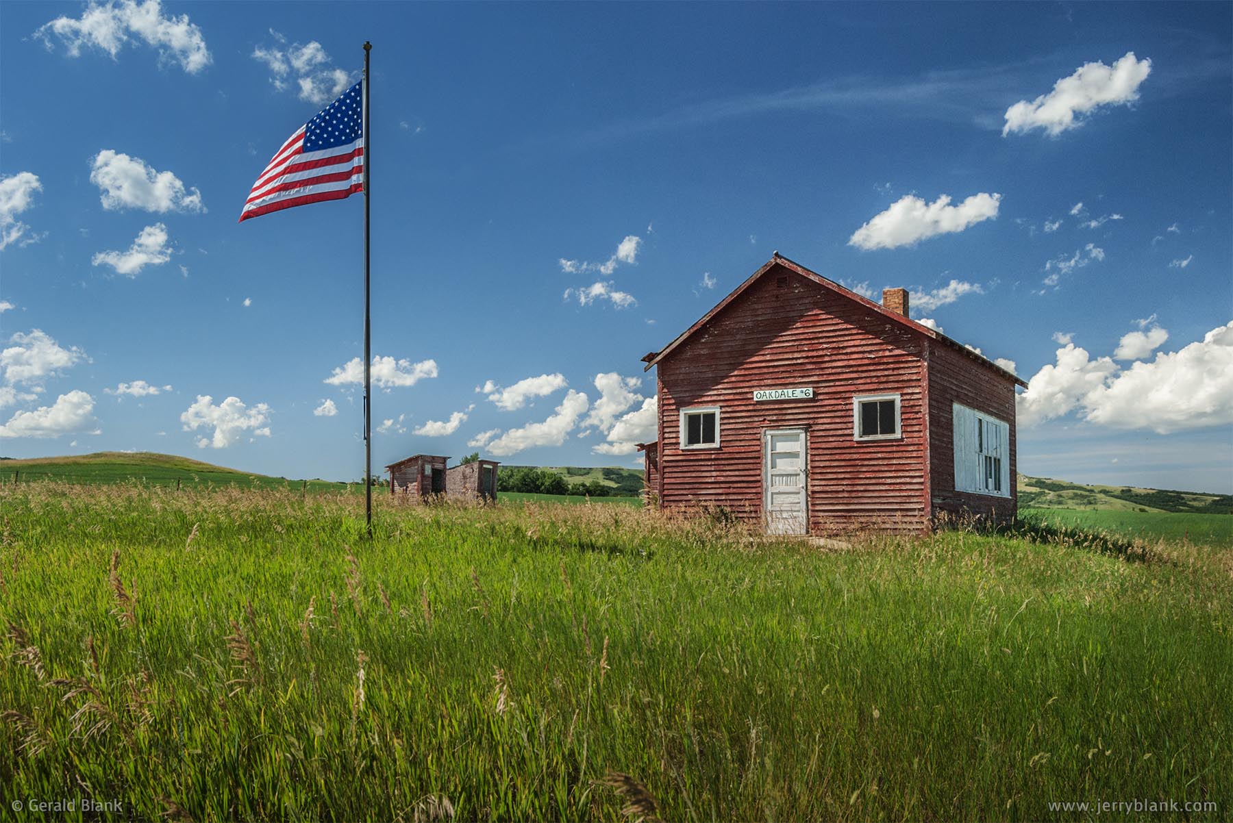 #01028 - On Independence Day, the U.S. flag is raised at the historic Oakdale School building in Dunn County, North Dakota - photo by Jerry Blank