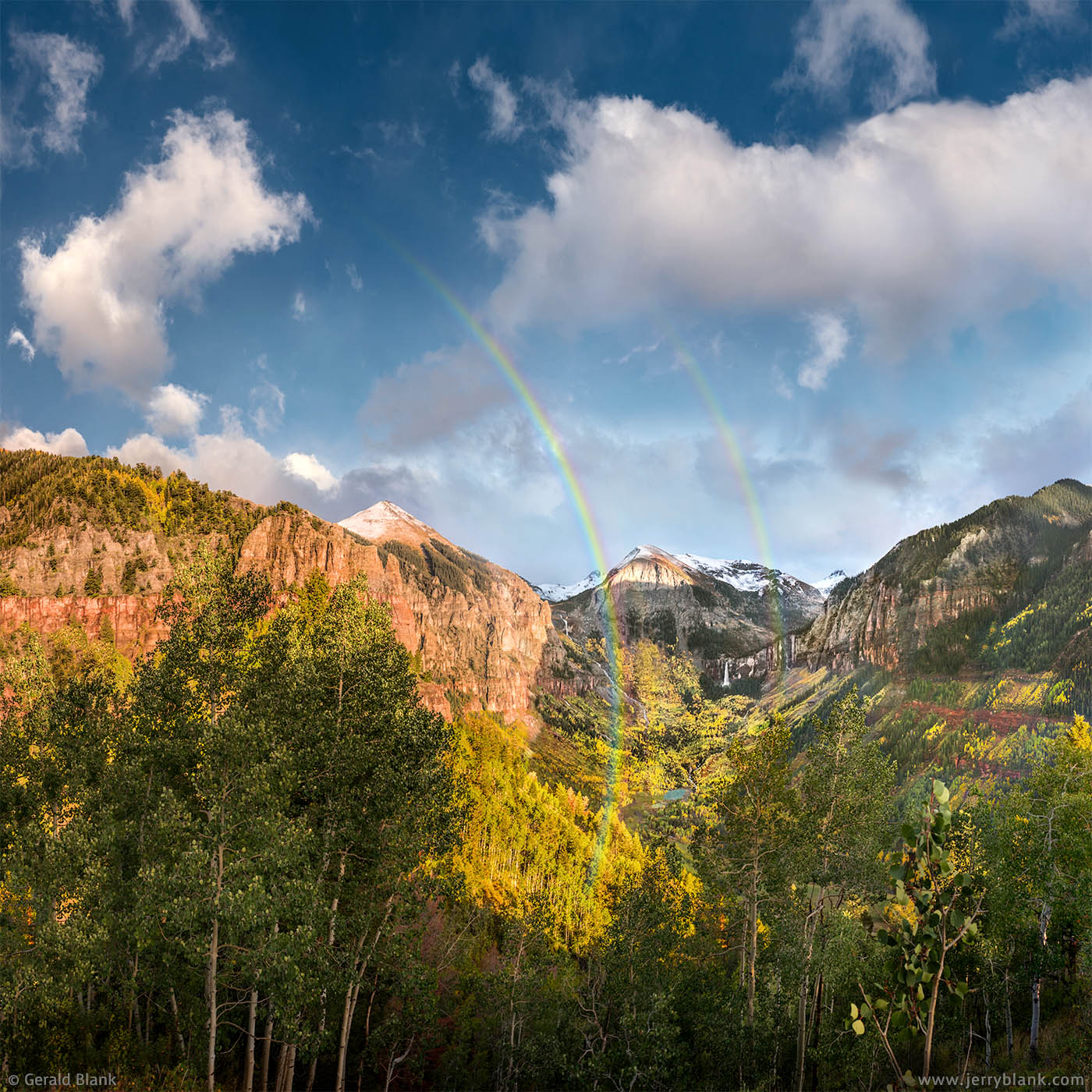 #49450 - A late evening double rainbow lights up the San Miguel canyon east of Telluride, Colorado. Ajax Peak, Ingram Falls, Ingram Peak, and Bridal Veil Falls are visible in the distance. Photo by Jerry Blank.