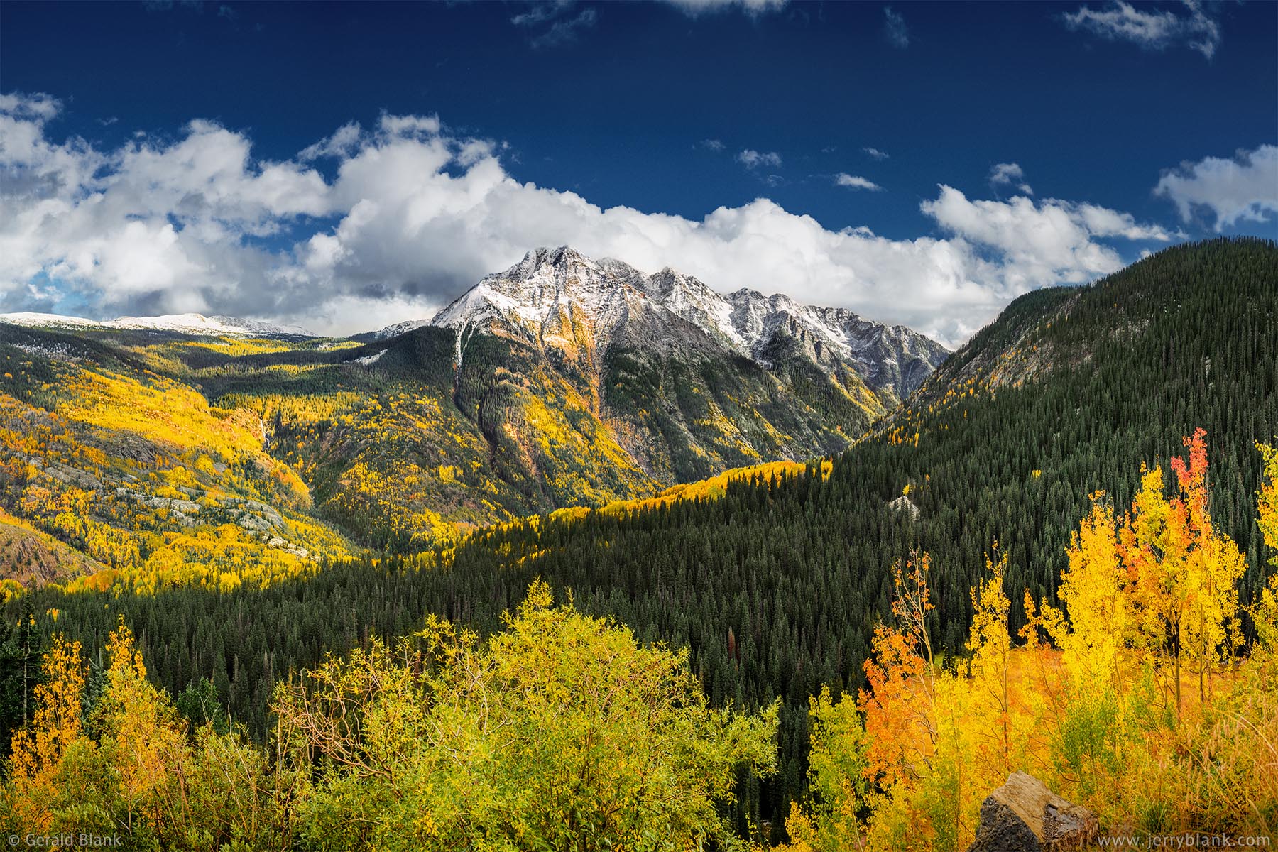 #52266 - The Twilight Peaks, in Colorado’s San Juan Mountains, are surrounded by vivid autumn color in this view from Coal Bank Pass on US Highway 550