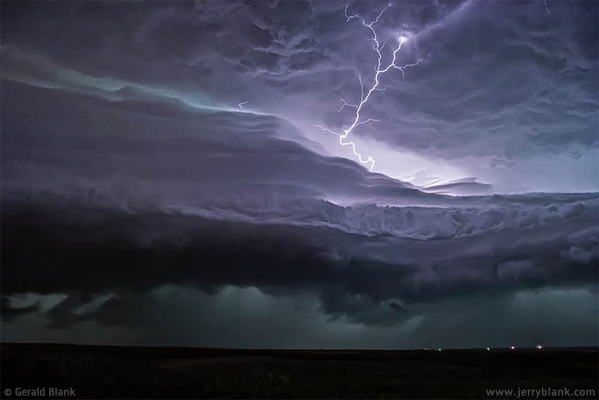 #01907 - Lightning illuminates approaching storm clouds, north of Williston, North Dakota - photo by Jerry Blank