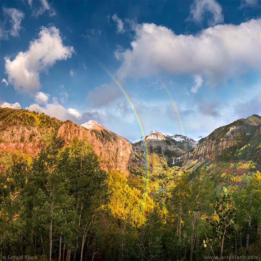 #49450 - A double rainbow lights up the San Miguel canyon east of Telluride, Colorado. Ajax Peak, Ingram Falls, Ingram Peak, and Bridal Veil Falls are visible in the distance - photo by Jerry Blank