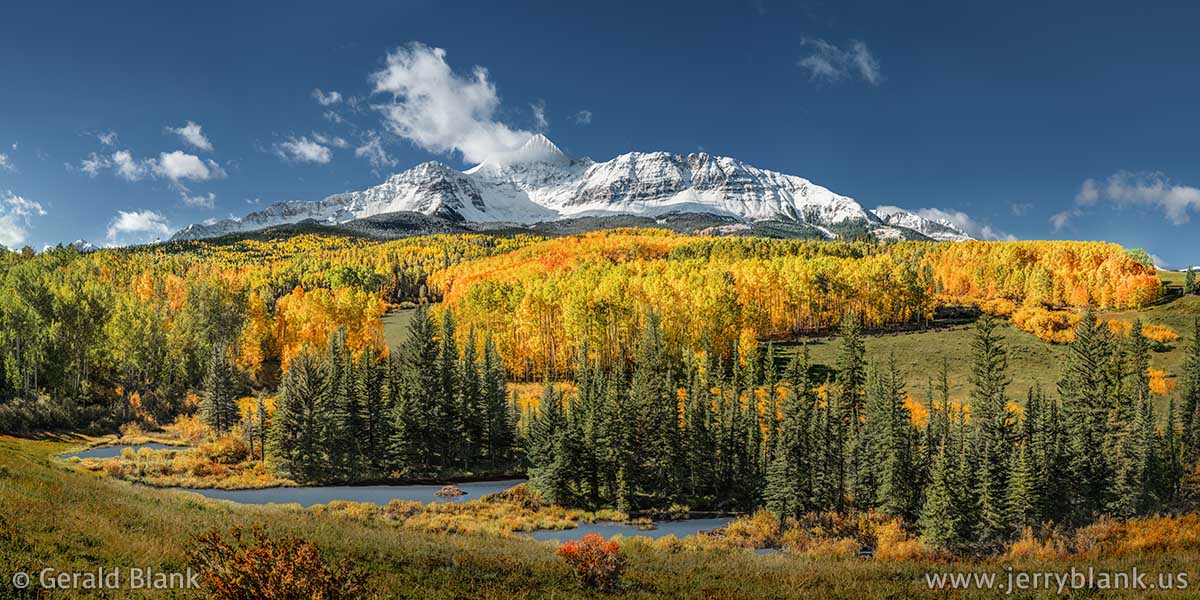 #50437 - Autumn colors blanket the lower slopes of Wilson Peak, above a chain of beaver ponds on Muddy Creek, in the San Miguel Range of Colorado - photo by Jerry Blank